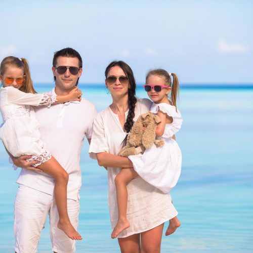 family-in-white-clothes-on-a-beach-free-photo